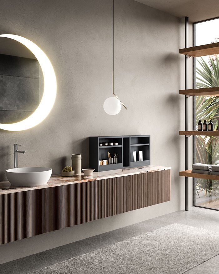 Badezimmer von ARAN mit Waschtisch aus Holz und rundem Spiegel